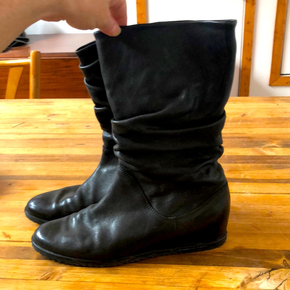 Black leather city pull-on boots by Stuart Weitzman